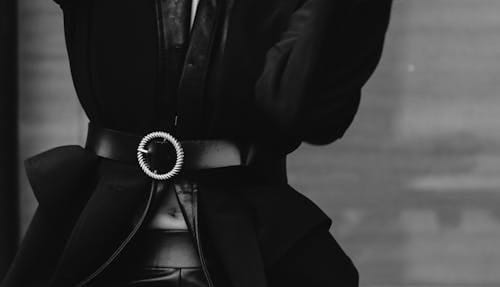 Free Black and white of trendy ethnic female in earrings with cigarette and closed eyes standing with head thrown back Stock Photo