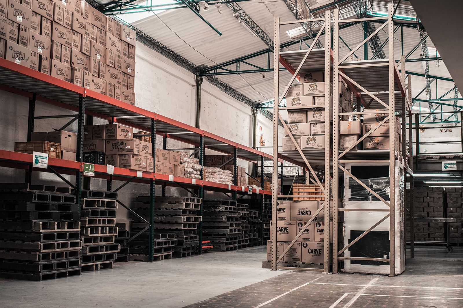 Warehouse storage racks filled with pallets and stacked cardboard boxes for inventory management
