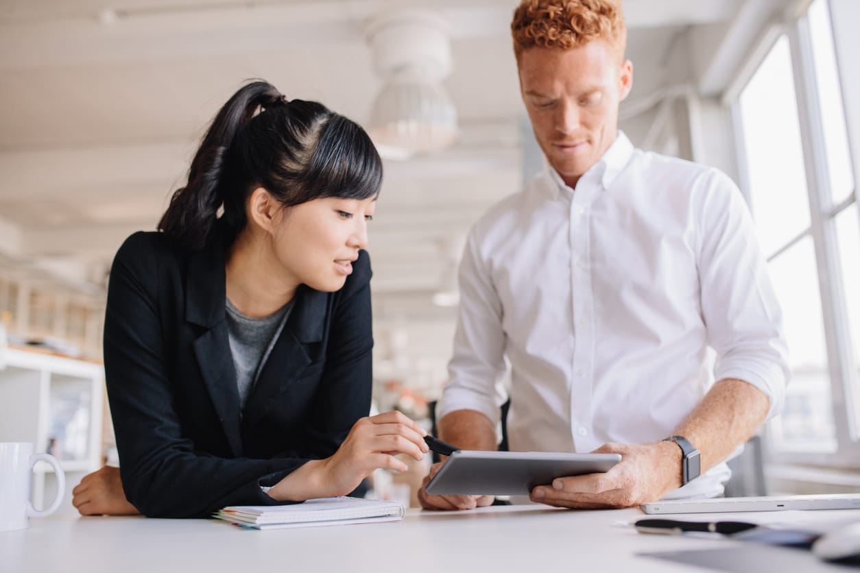 Business people working together on digital tablet in modern office