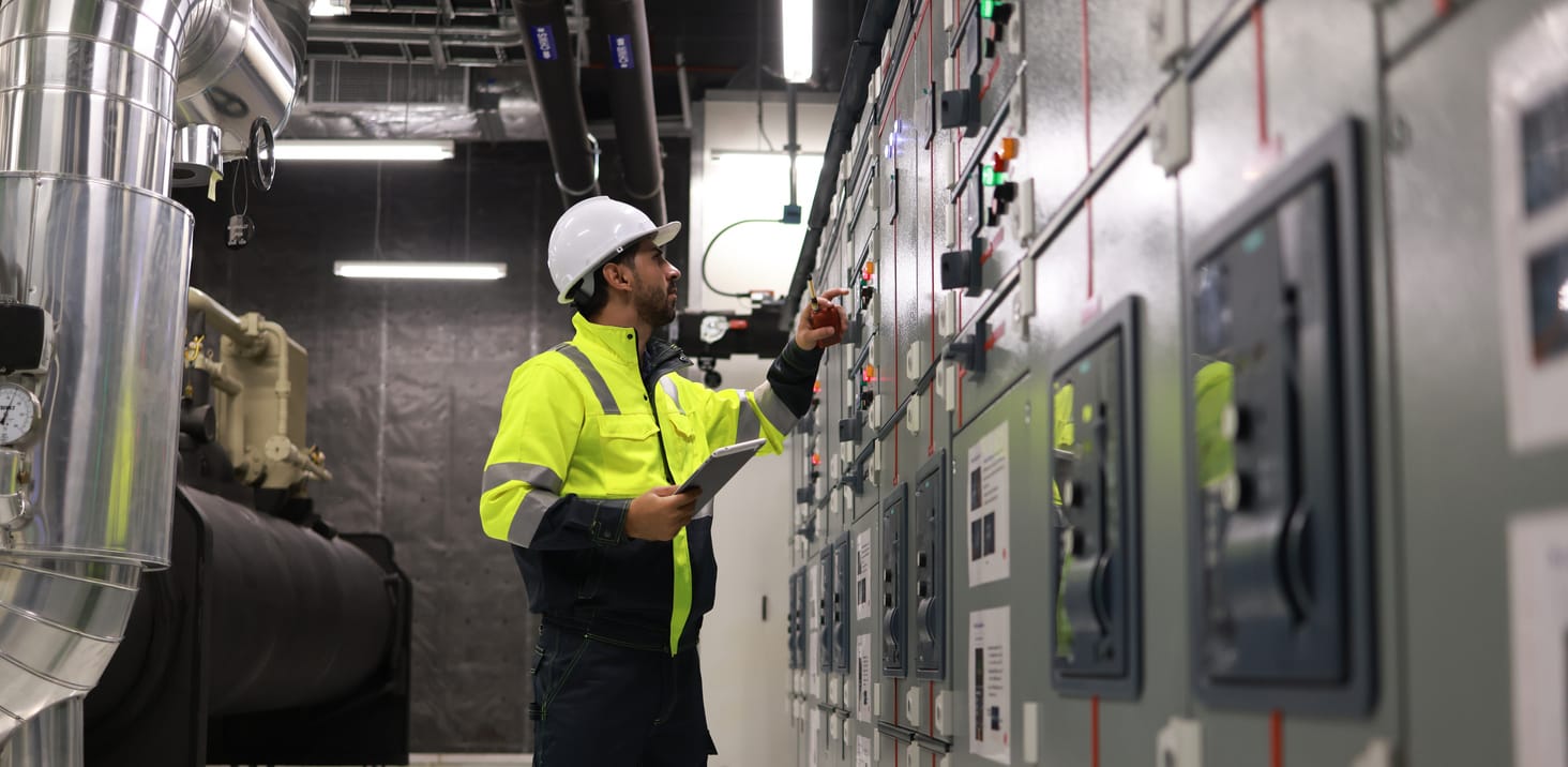 Engineers working in the main control room of a chiller HVAC system.