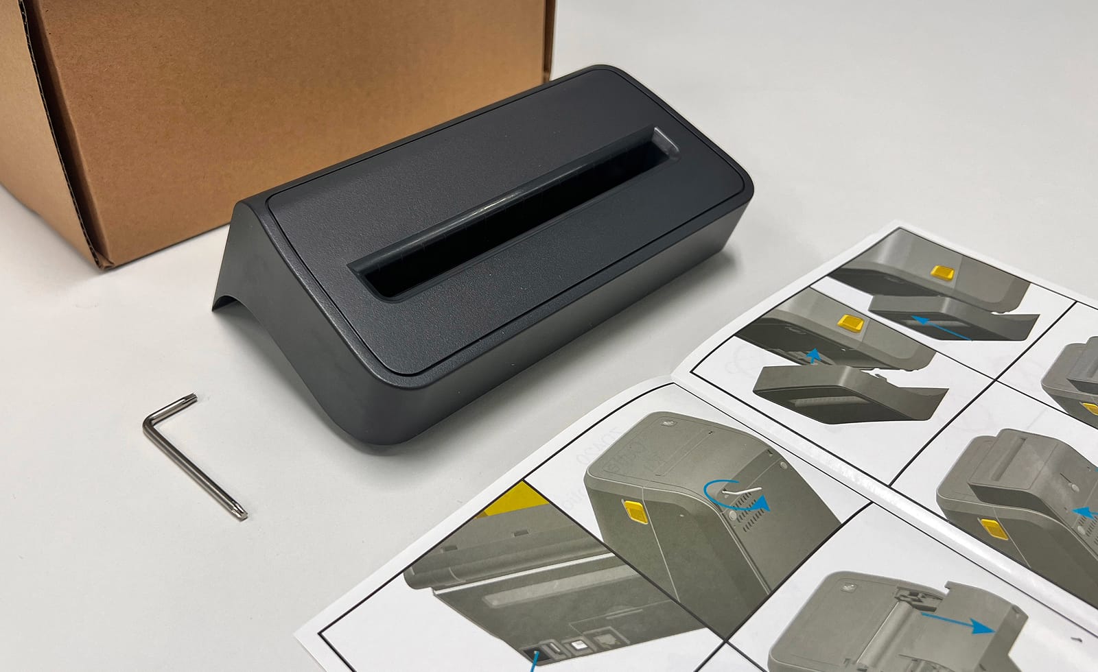 Unboxed label printer with setup guide, tools, and packaging for initial installation and setup