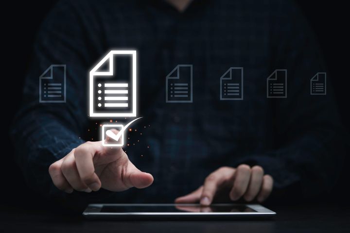 Businessman using tablet and touching on online document icon 