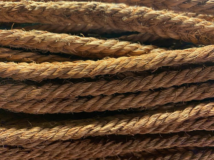 Golden brown, rough-looking rope cords running all in the same horizontal direction.