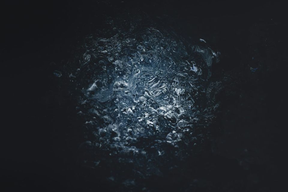 A dimly lit, watery surface.