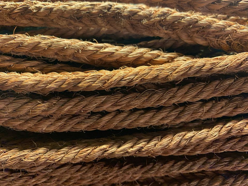 Golden brown, rough-looking rope cords running all in the same horizontal direction.