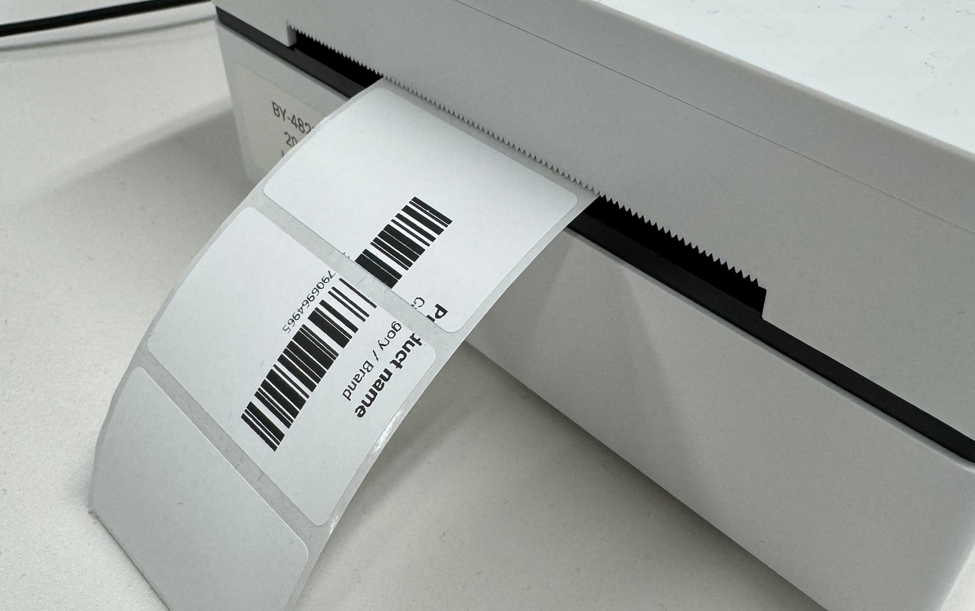 A thermal label printer with a freshly printed shipping label rotated sideways
