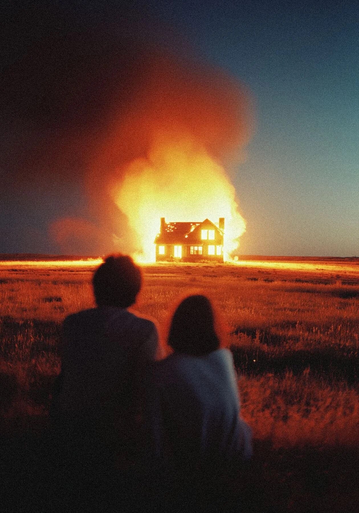 Two figures watch a farmhouse burn under a night sky — Vagabond Diary
