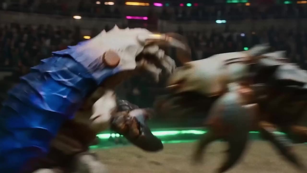 A blue-scaled creature and an armored figure collide on an arena floor in front of a crowd