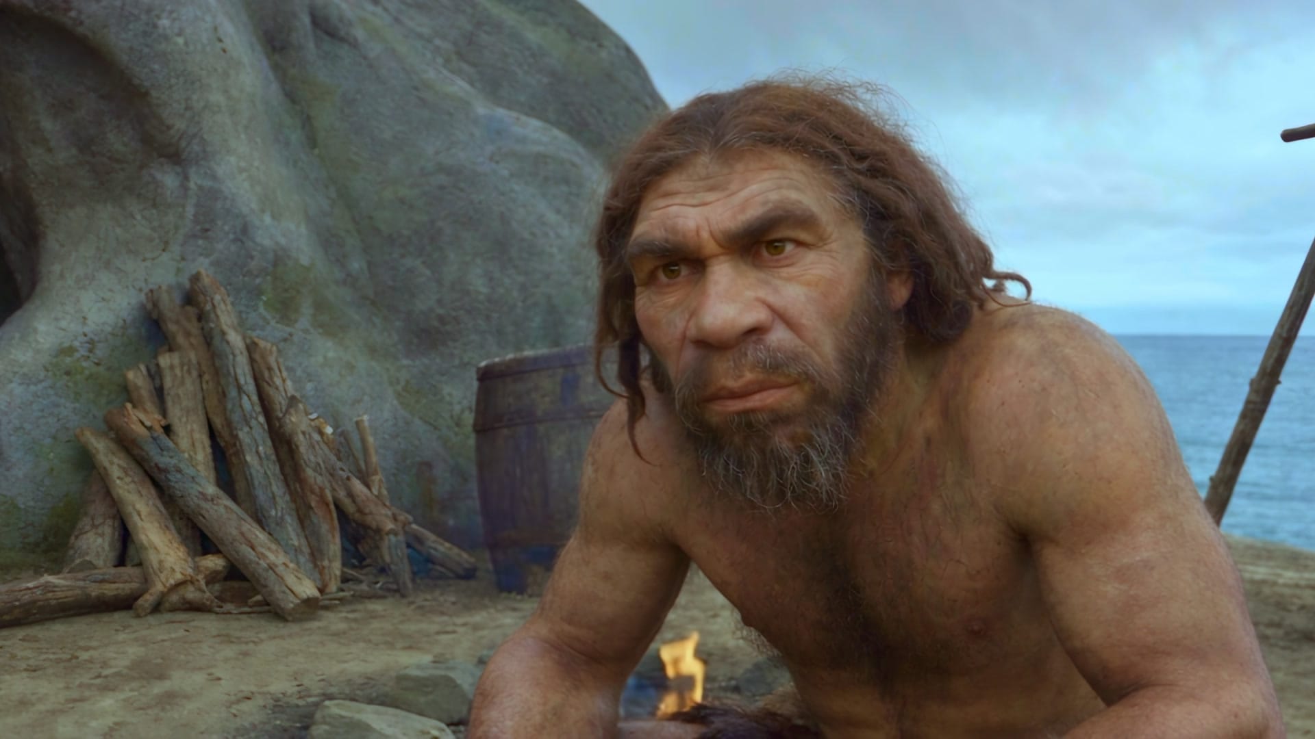 The Neanderthal seated for his interview in front of the cave, staring into the lens