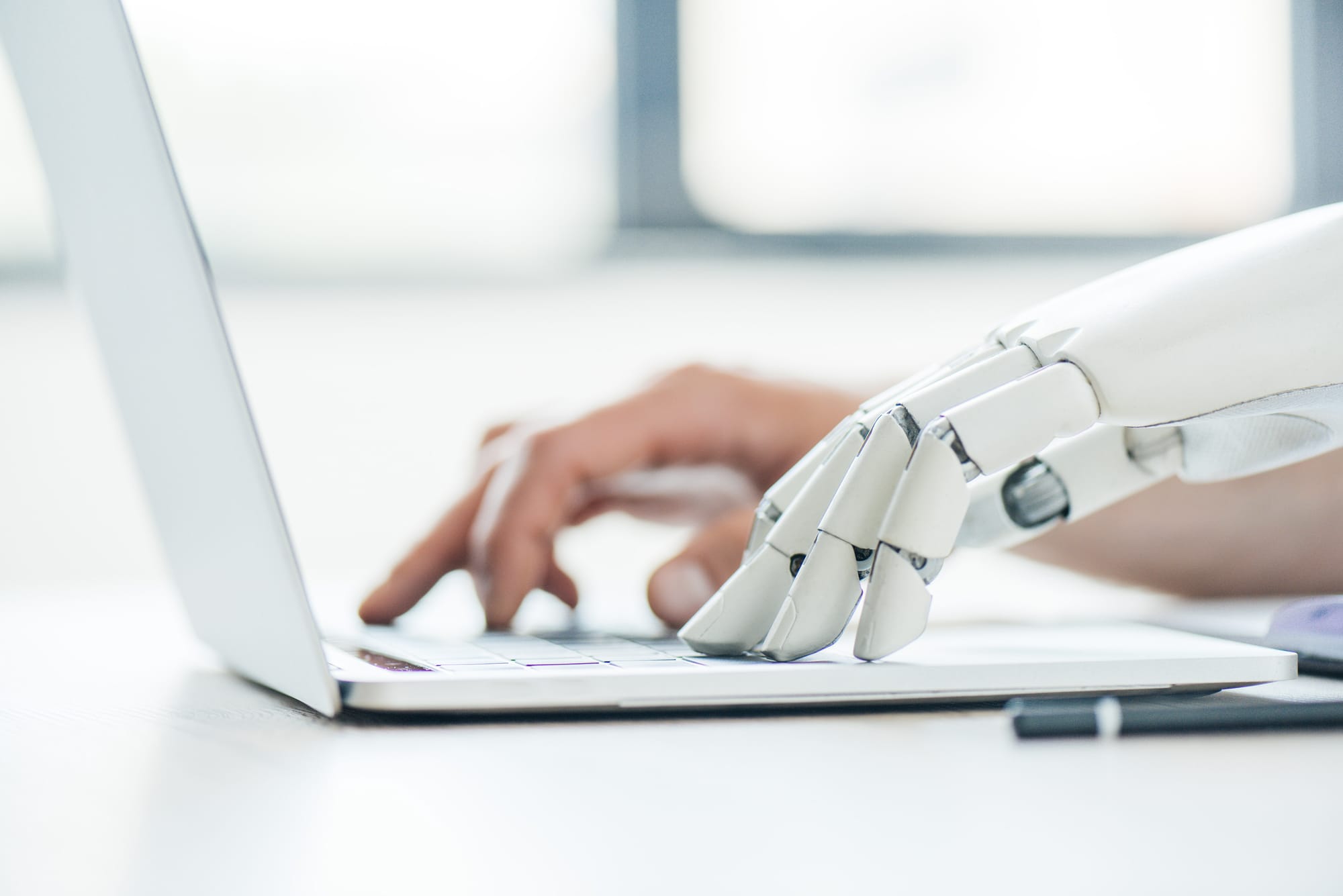 Human and AI robot on laptop