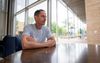 Ron Blake seated at a table during an interview, talking about his experience with Police LGBTQ Programs and liaisons in Phoenix.