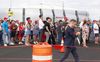 A crowd of people standing in line to attend Charlie Kirk's memorial service, located at State Farm Stadium in Glendale, Arizona.