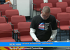 An image of a man standing at a podium at the Senate Government Committee, wearing a "Protect Believe Love Trans Kids" shirt, likely speaking about transgender rights in Arizona. 