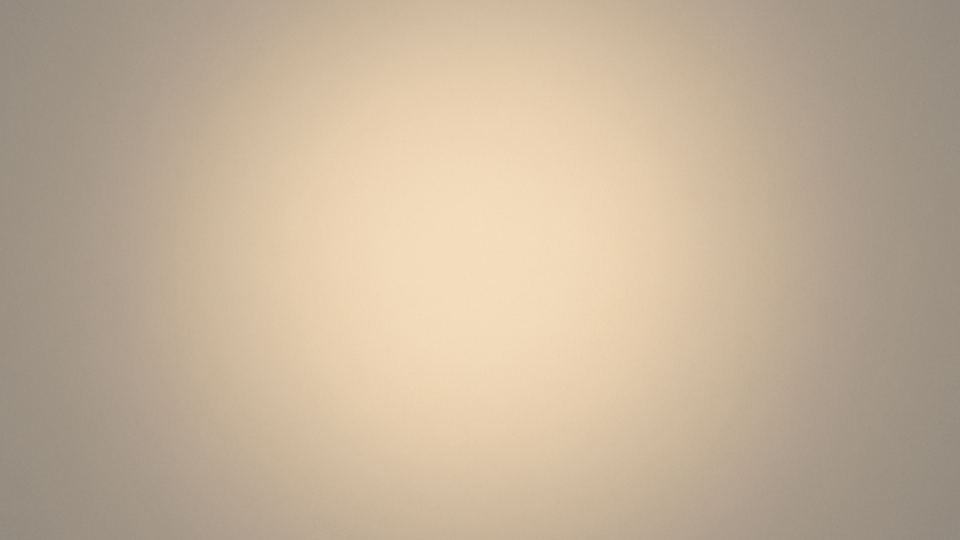 Abstract gradient image with a soft central glow fading into muted neutral tones.