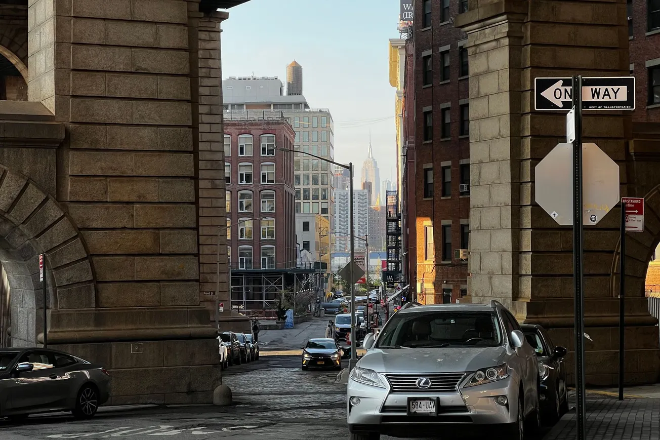The Empire State Building from underneath the Manhattan Bridge, Brooklyn, NY (2022) [Frederick Lane]
