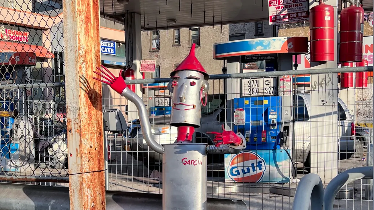 A photo of a vaguely-humanoid gas station sculpture, The Bronx, New York [Frederick Lane, 2022]