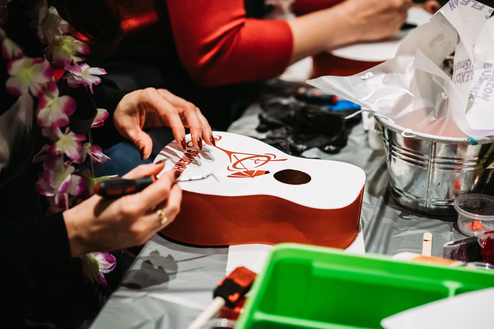Decorating a ukulele at a bachelorette party.
