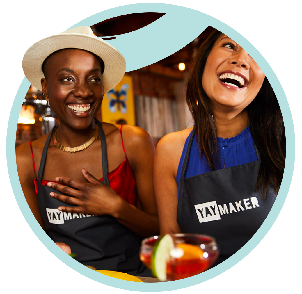 Girl friends laughing together at Paint Nite