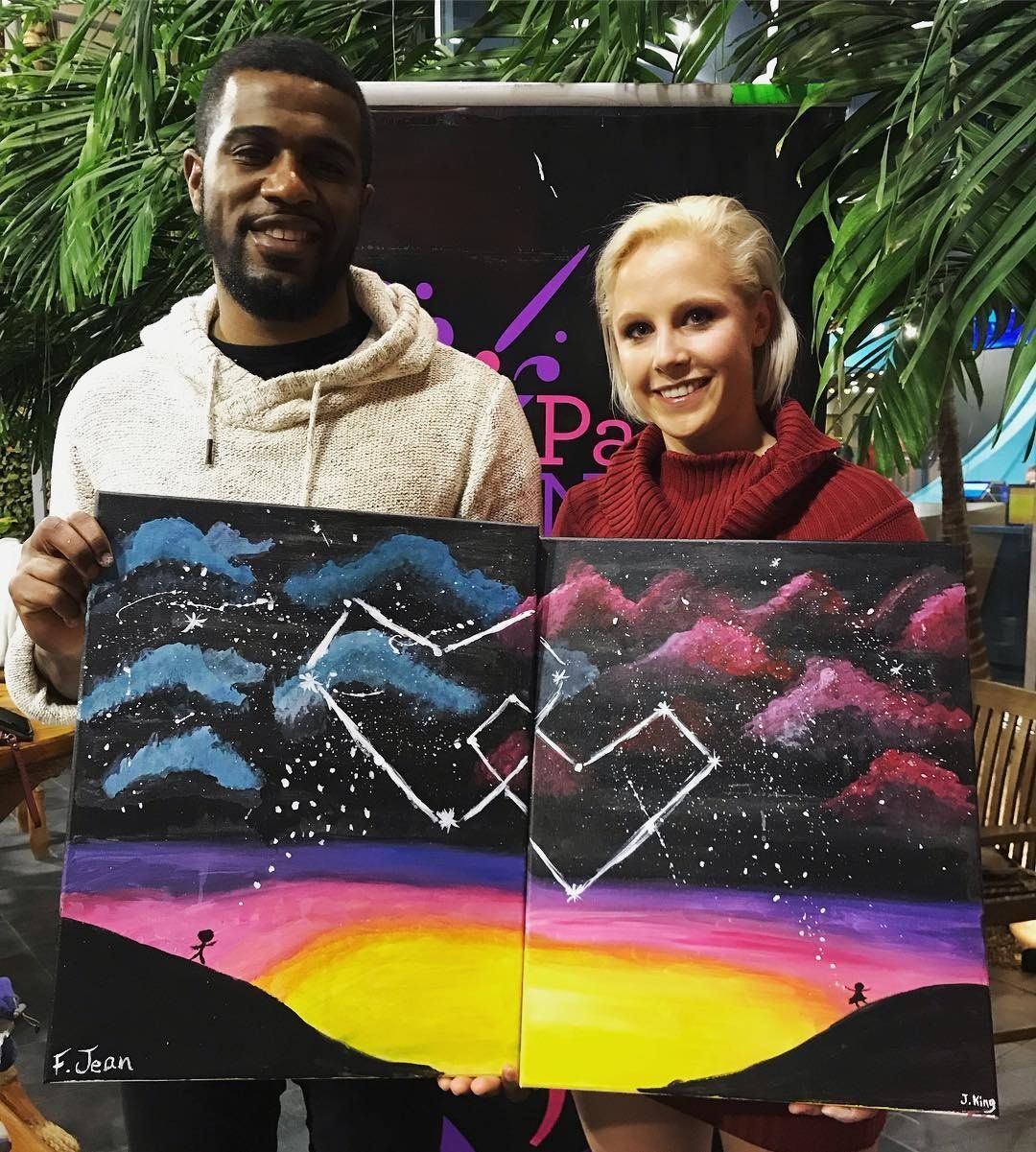 Couple showing finished painted hearts in the sky