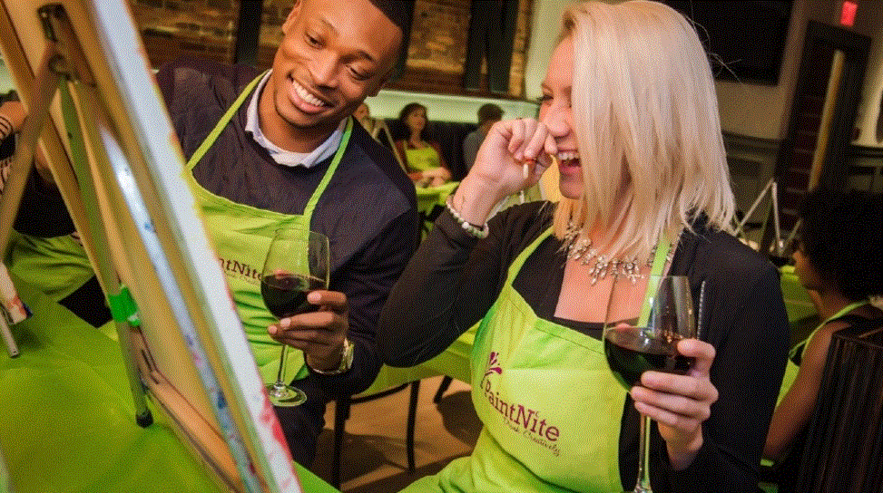Couple having fun at a Valentine's Day paint and sip event