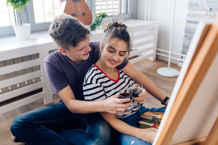 Couple doing a virtual paint night at home for Valentine's Day