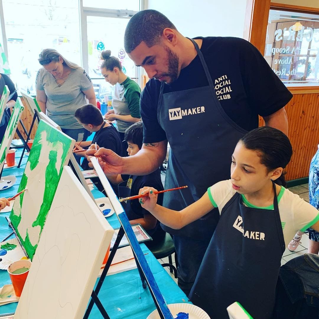 Father and child painting at a kids paint and sip with Paint Nite/Yaymaker