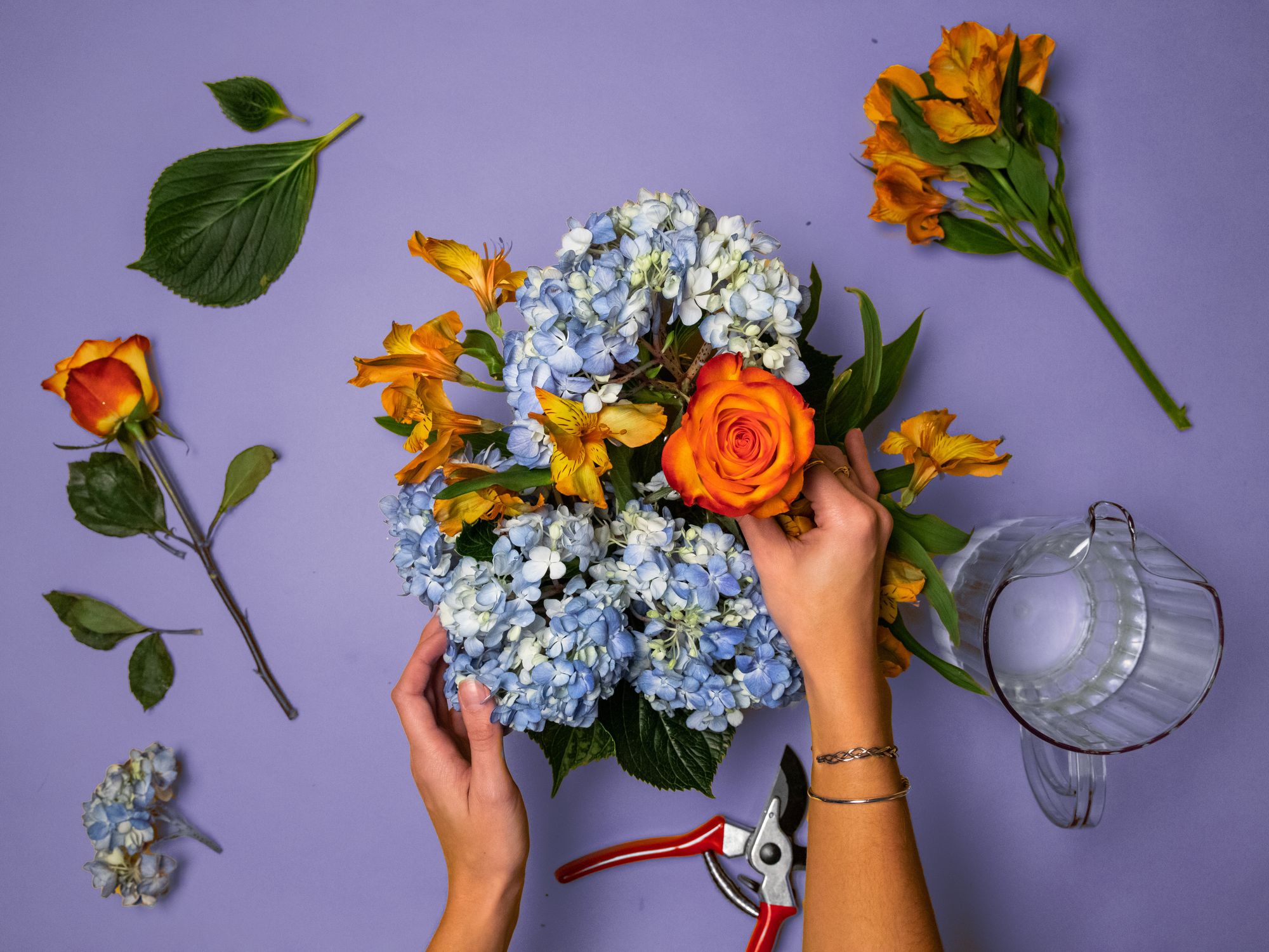 Person arranging flowers for a bouquet