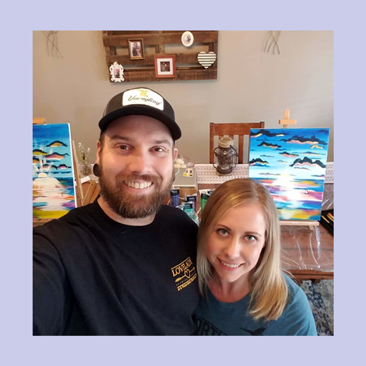 Couple smiling at paint and sip date at home