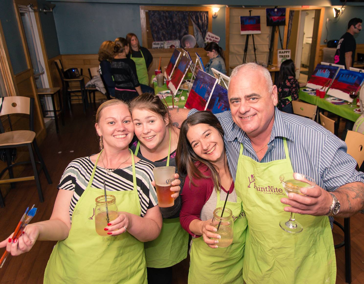 Family posing at Paint Nite eatertainment event