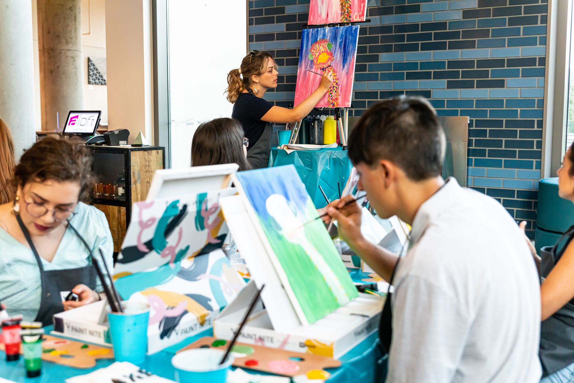 Group at an in-person Paint Nite painting an emu