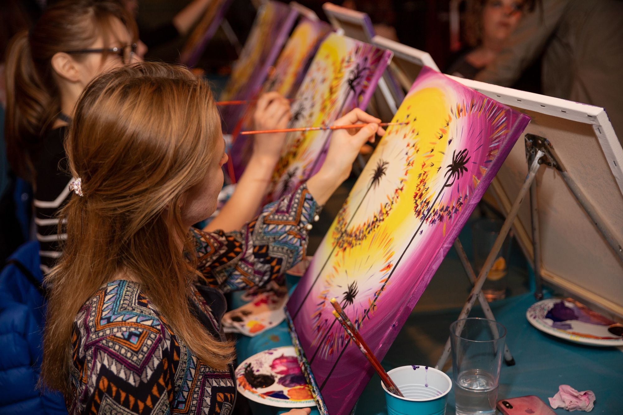 Group of women painting dandelions at Paint Nite