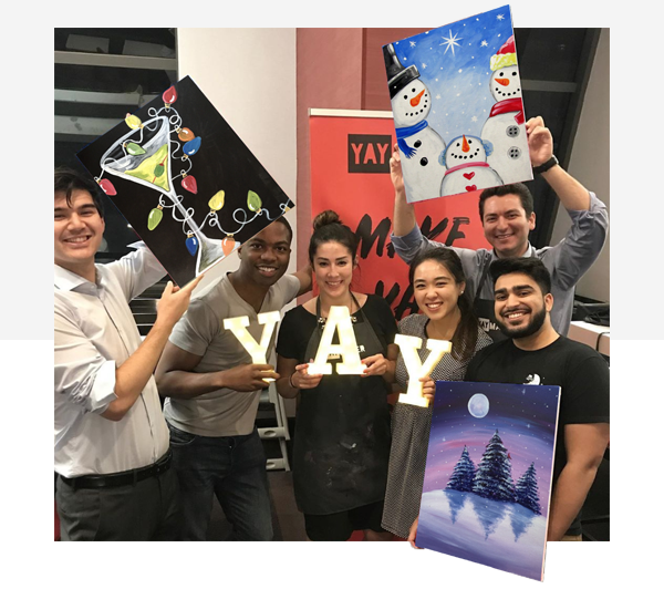 Group of friends holding finished paint night paintings