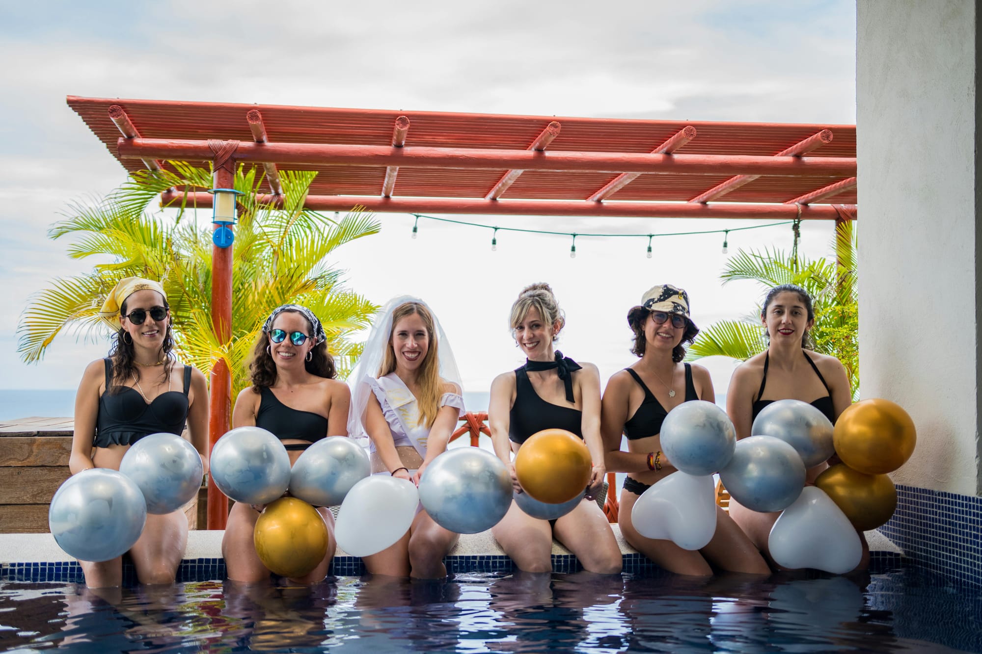 Bachelorette pool party with inflatable floats and drinks