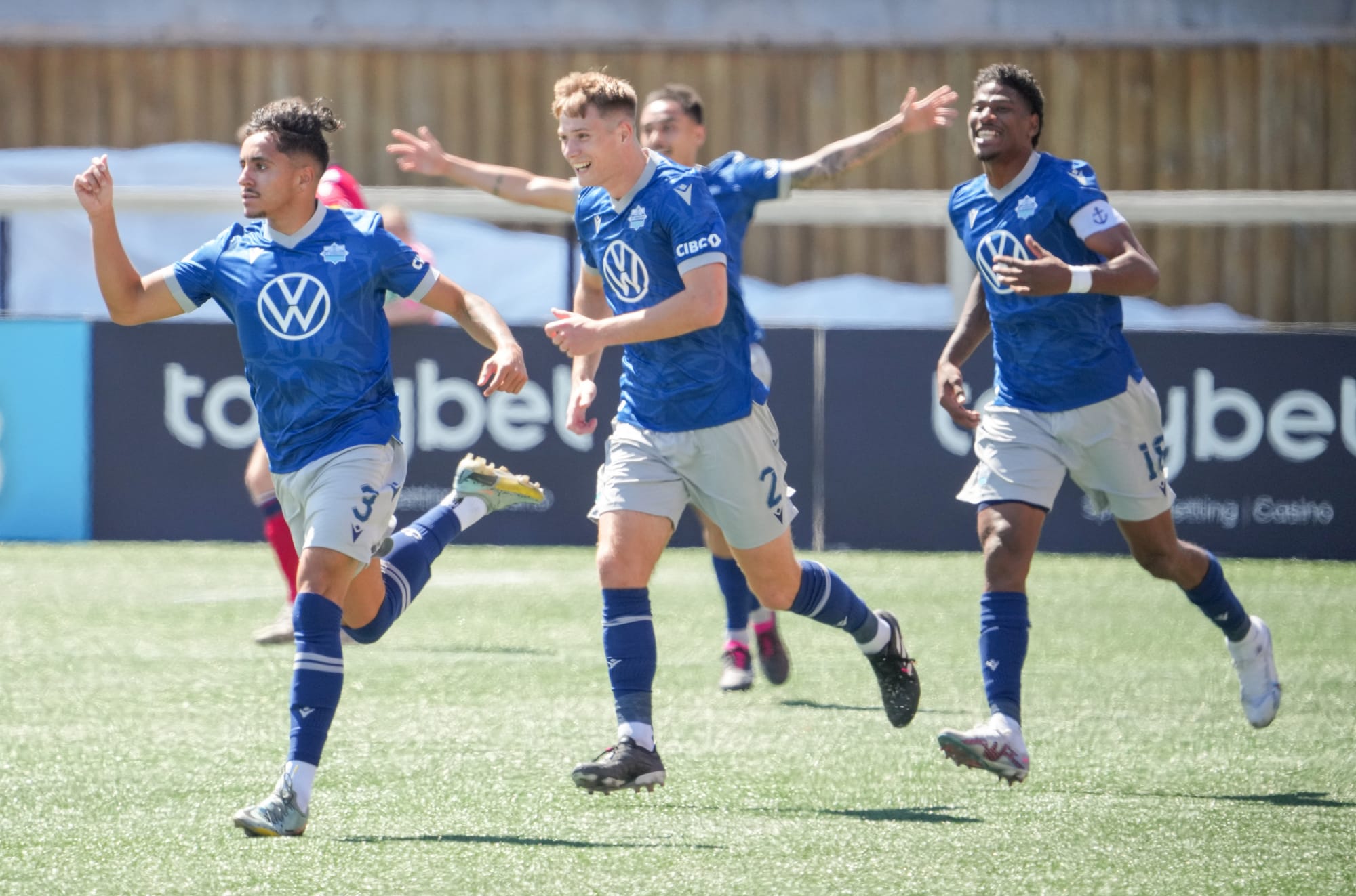 Halifax Wanderers centre-back Dan Nimick celebrates after his teammate Zach Fernandez scores a goal.