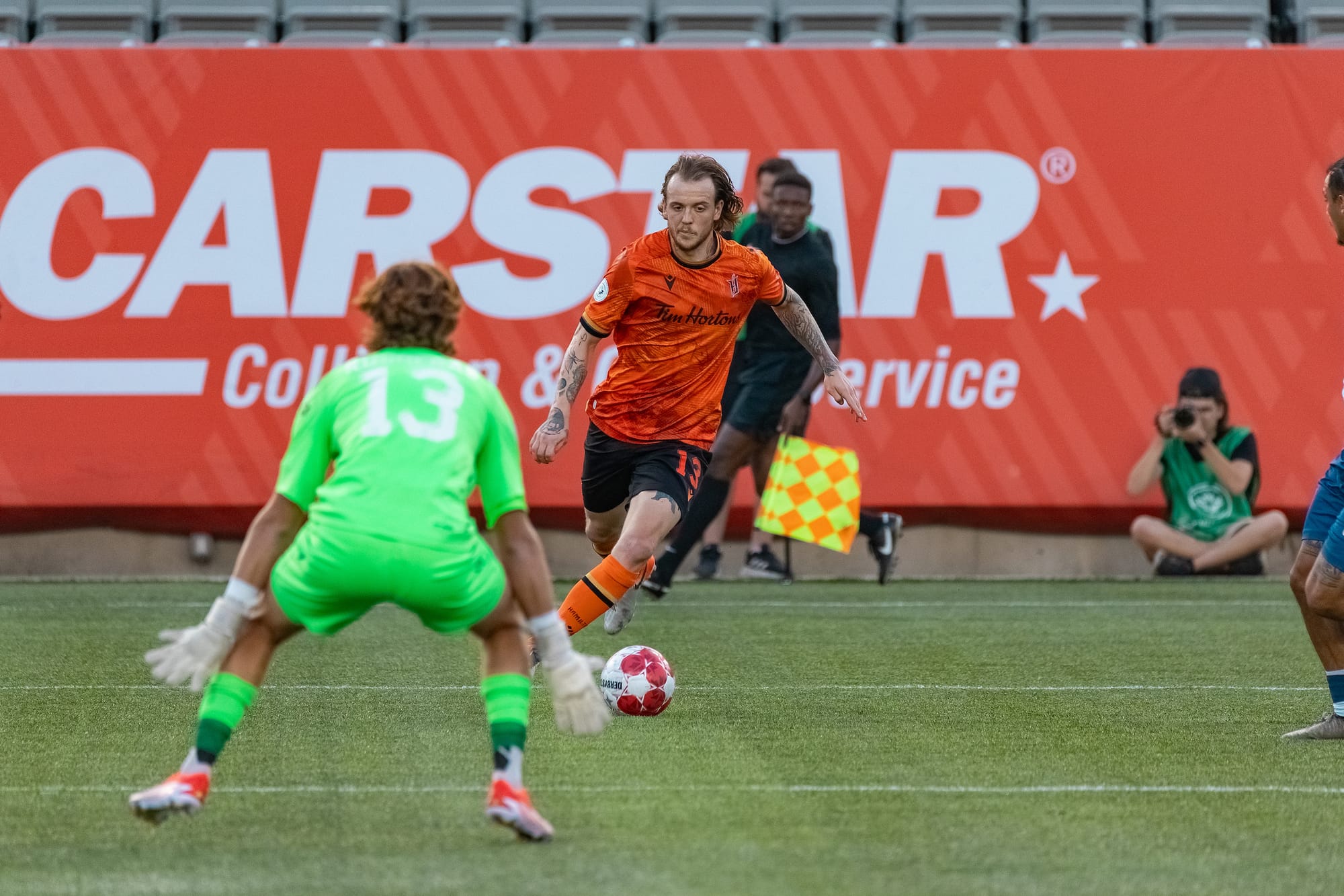 Halifax Wanderers goalkeeper Aiden Rushenas prepares for a shot from Forge's Alex Achinioti-Jonsson.