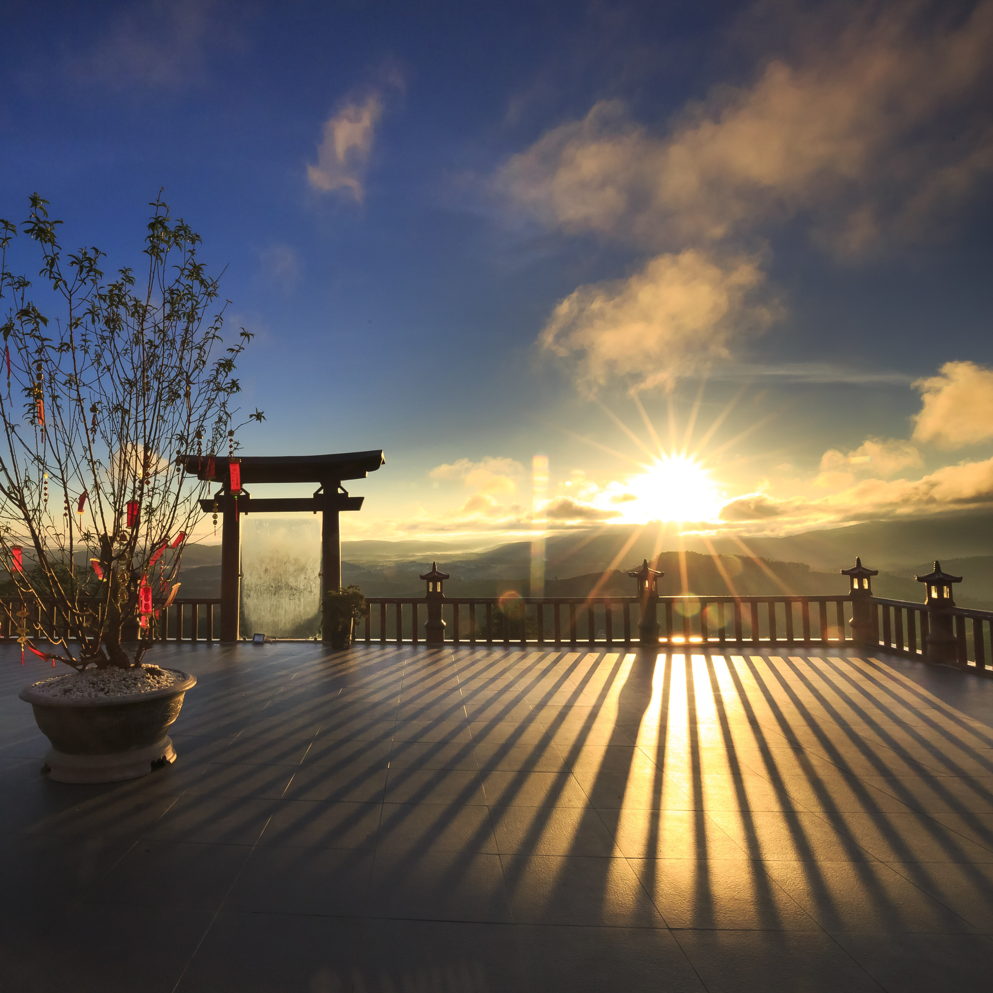 Photo of a sun setting from the vantage point of a Vietnamese temple 