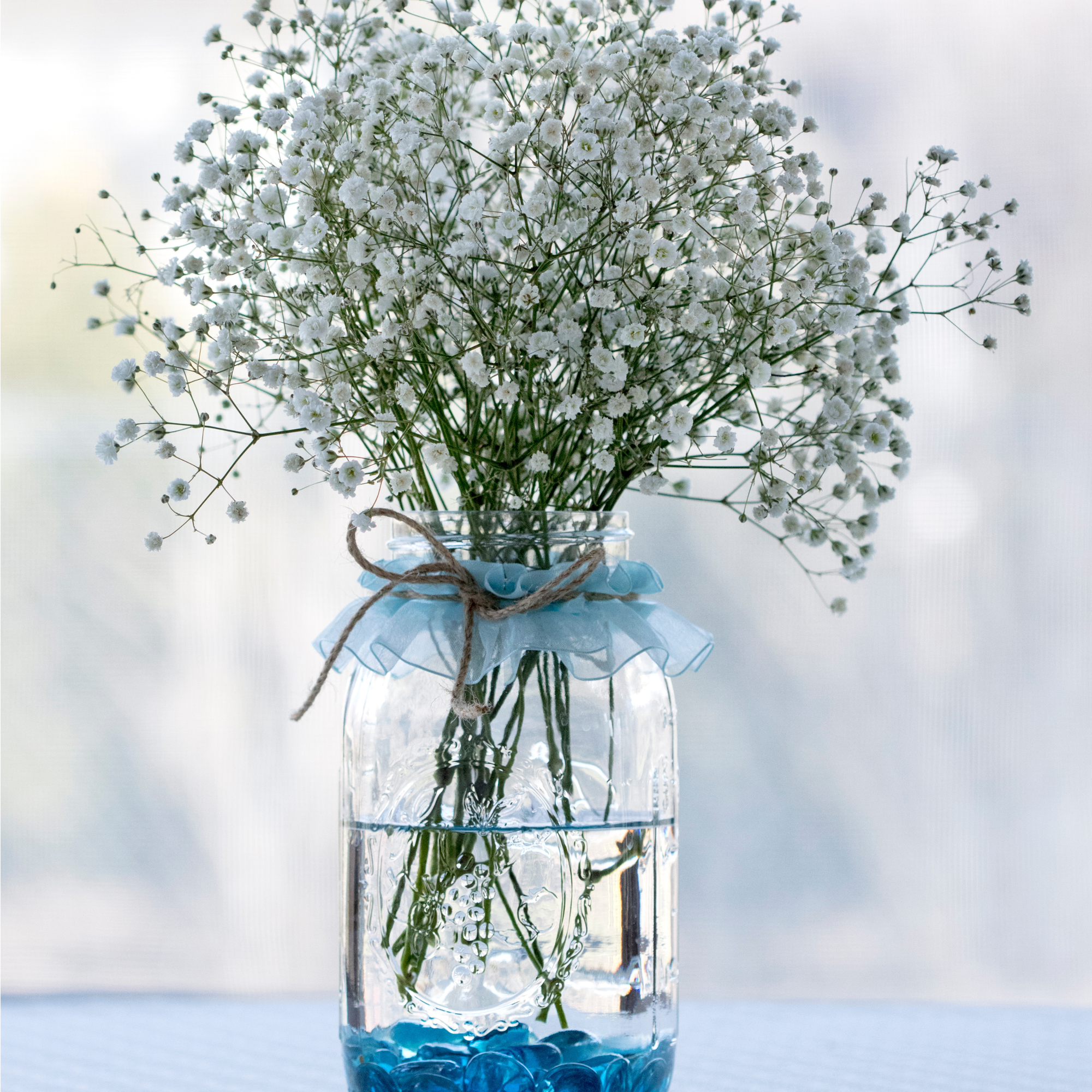 photo of a clear glass vase of baby's breath