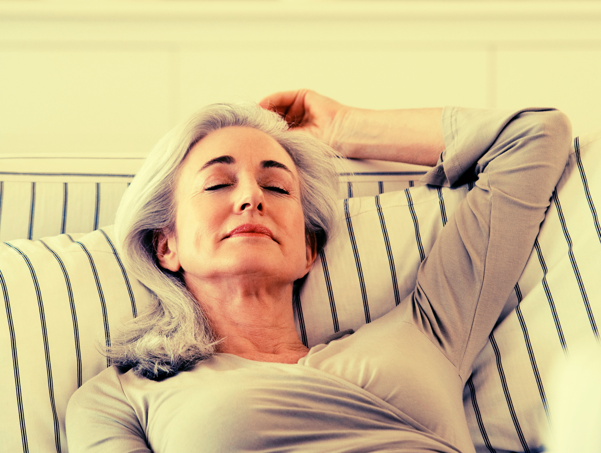 photo of a midlife woman resting on a sofa