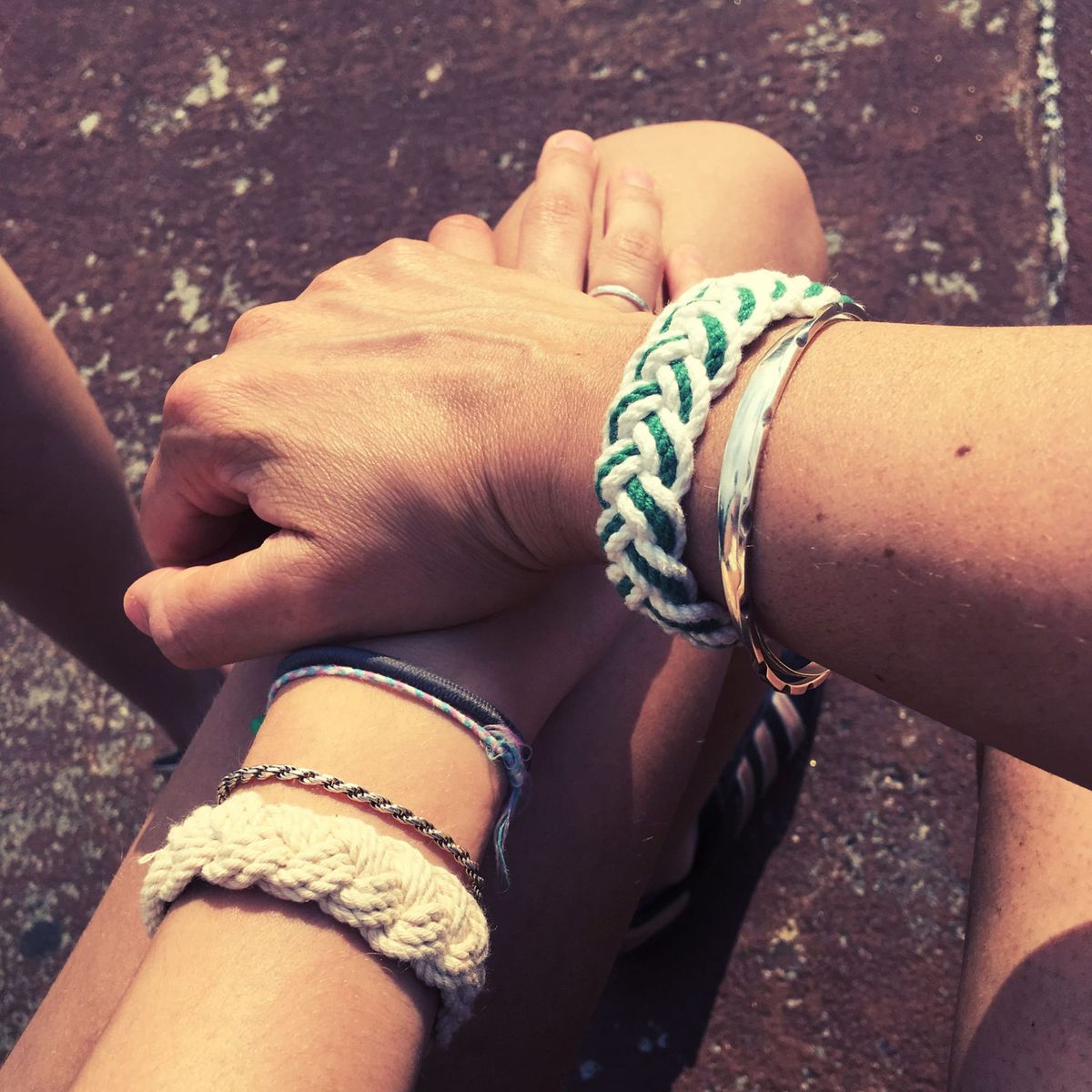 photo of interlocking hands and arms