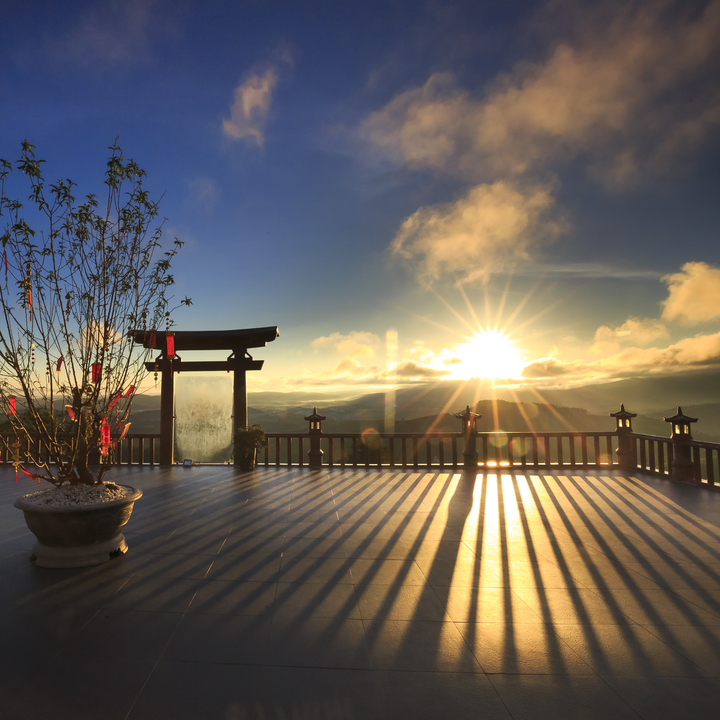Photo of a sun setting from the vantage point of a Vietnamese temple 