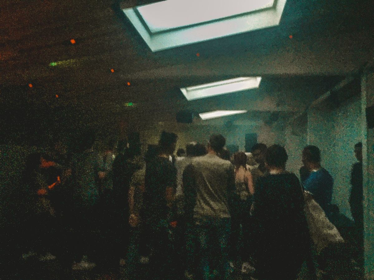 Pickle Factory, a dimly lit underground club in East London with a crowd of people dancing under skylights in the early morning.
