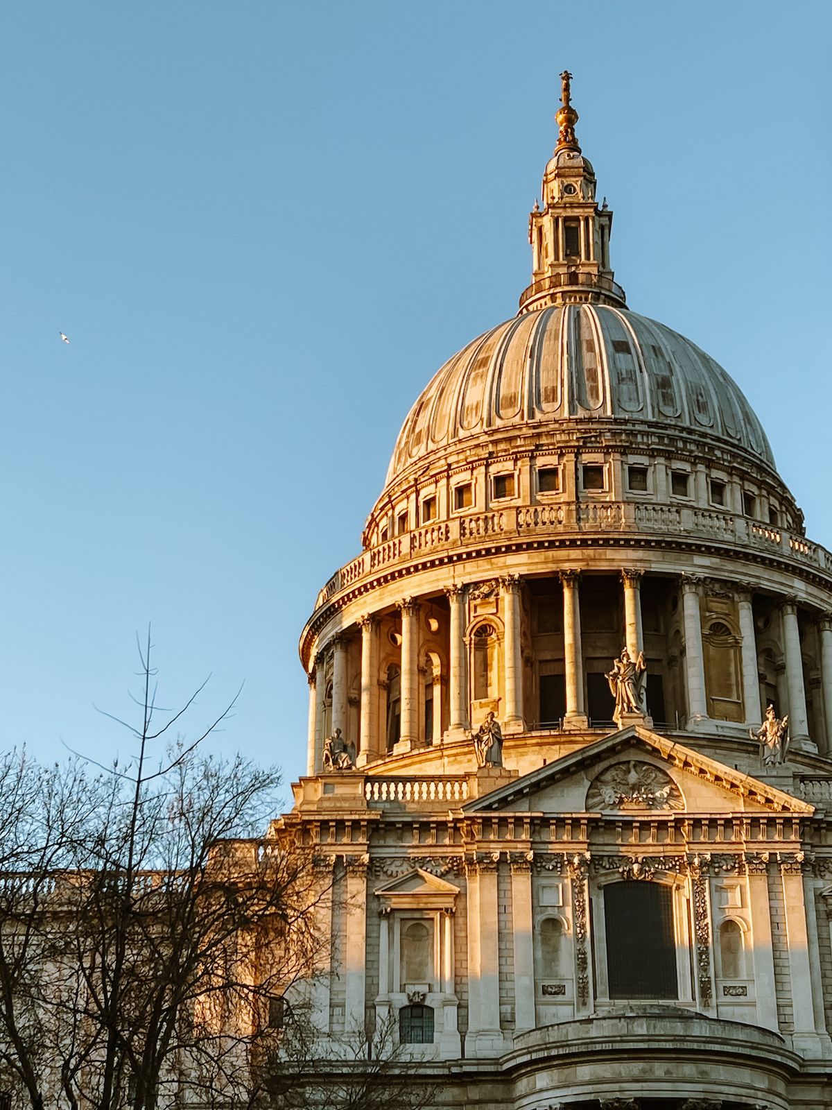  A close-up of the grand dome of St. Paul’s Cathedral, illuminated by golden light.