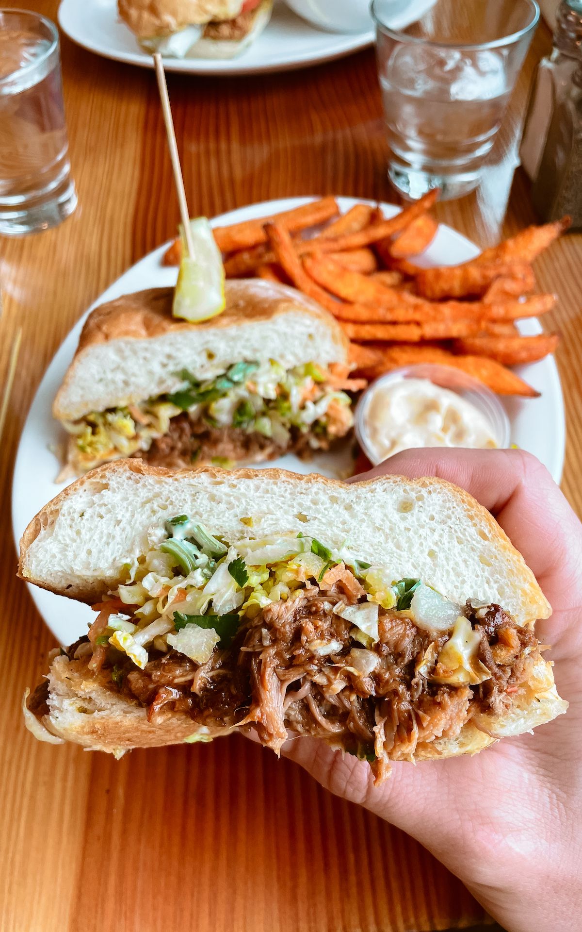 Pulled pork sandwich with slaw, sweet potato fries, and aioli at Rock Salt Restaurant on Salt Spring Island.