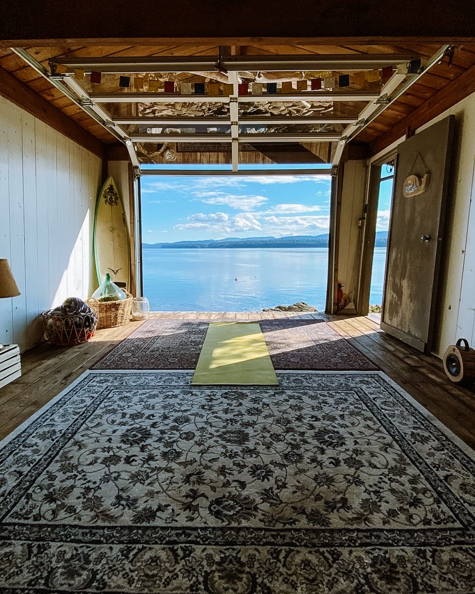A yoga mat sits in the spacious room of the detached boathouse at Waterfront Escape B&B with sweeping views of the ocean.