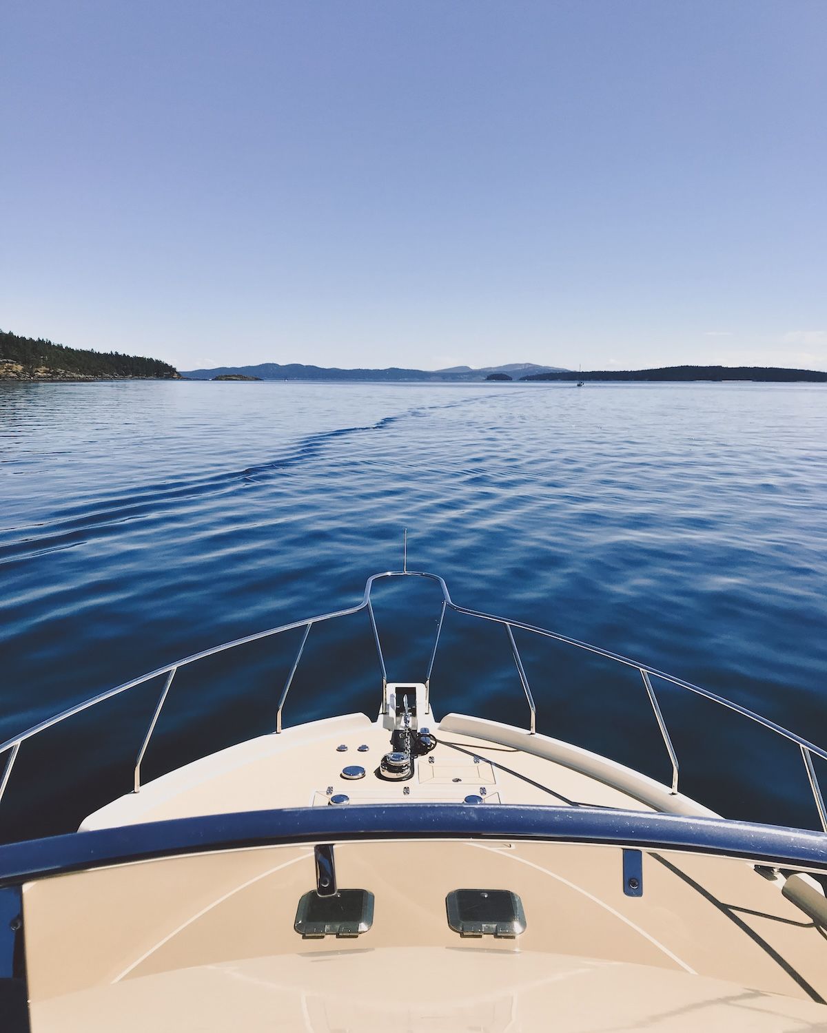 Bow of a boat cruising the calm waters, showcasing Galiano Island’s coastal beauty.