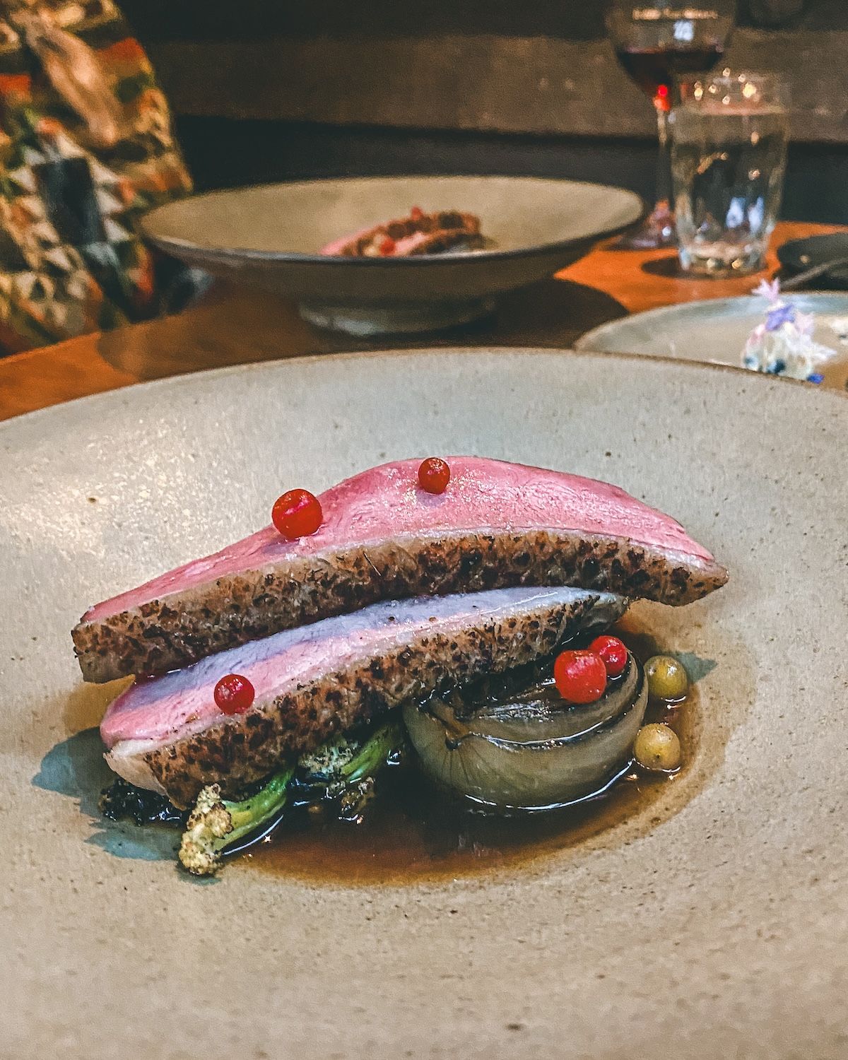 Plated duck breast with berries and vegetables at Pilgrimme.