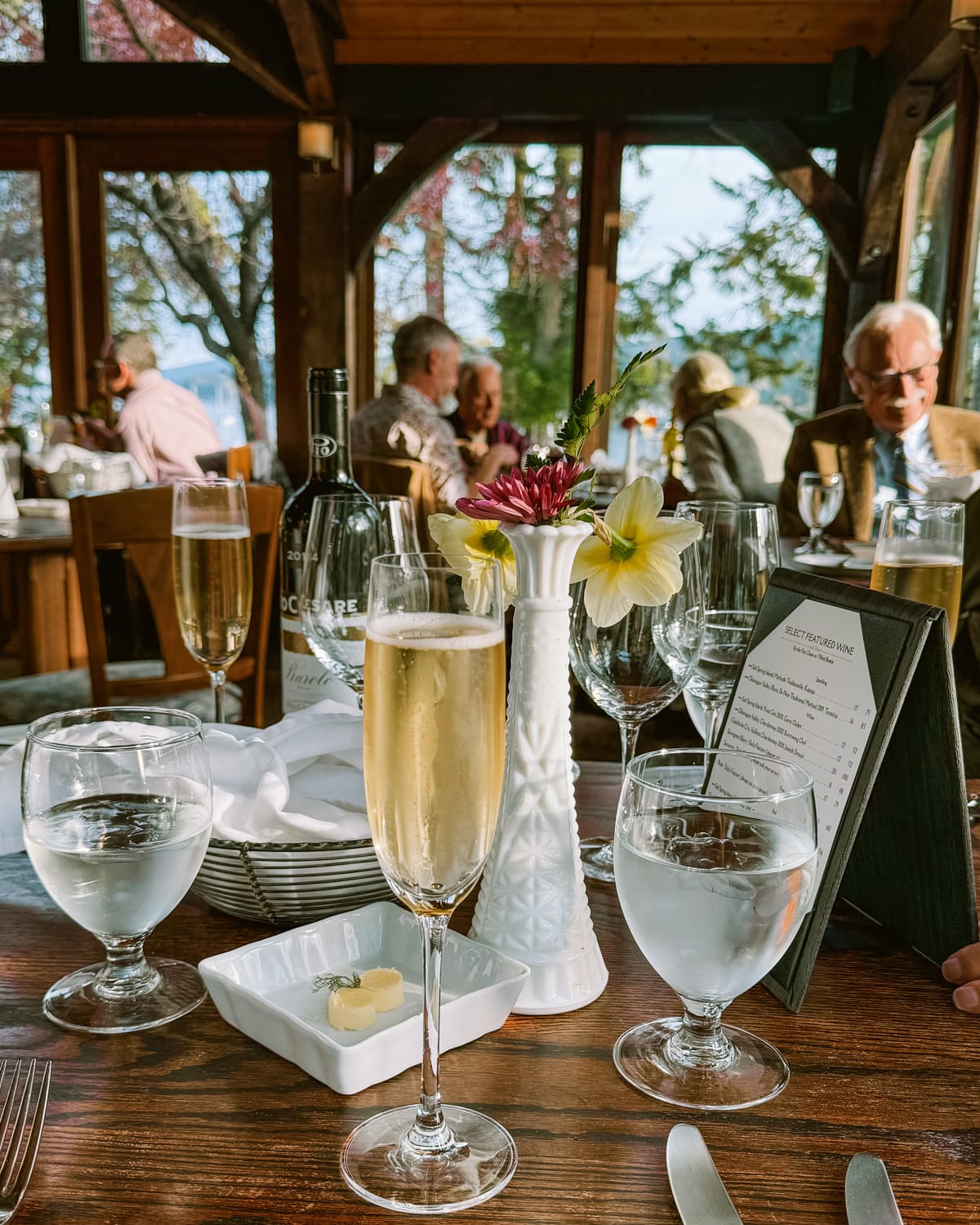 Elegant table setting at Hastings House with champagne flute, wine glasses, and floral centerpiece.
