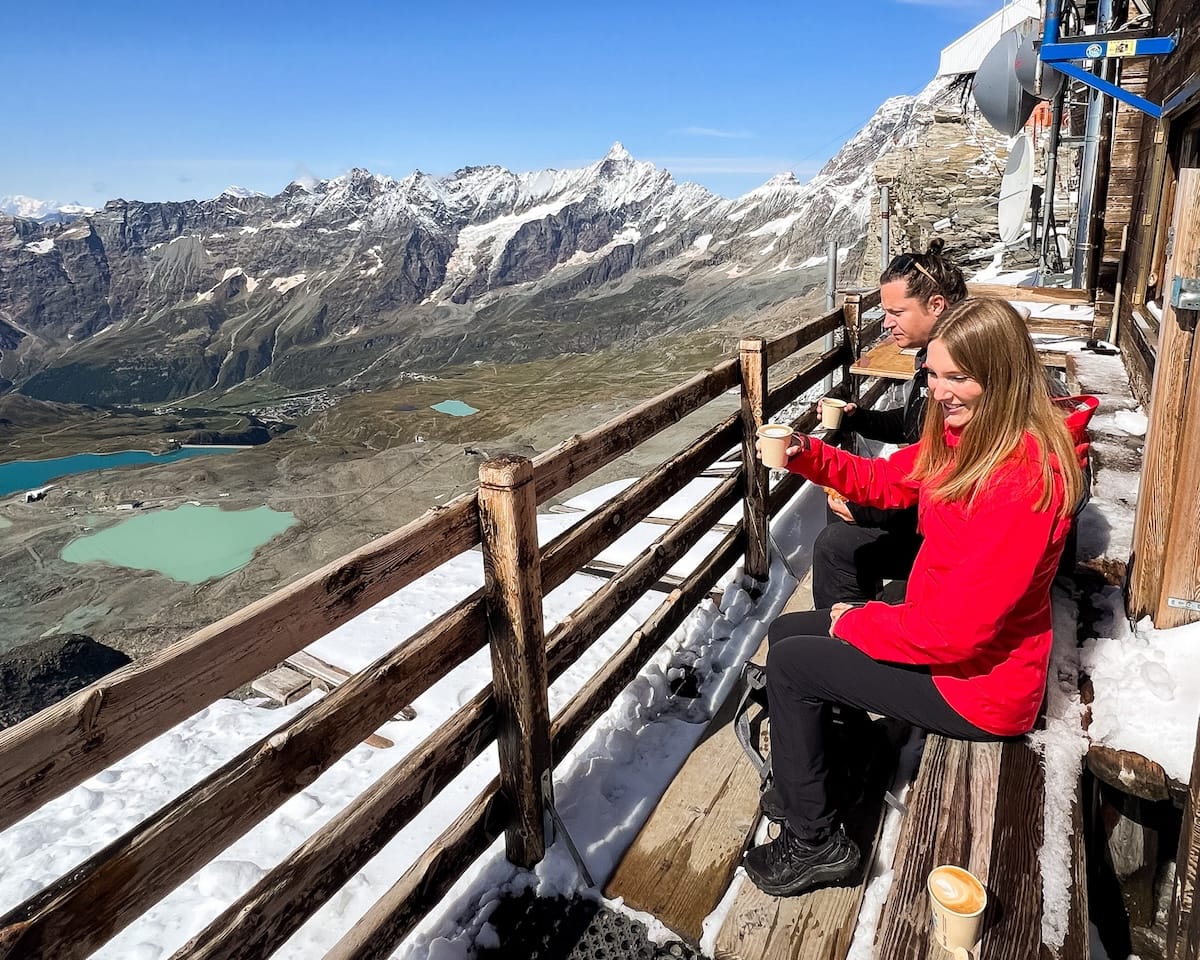 Ari and Cecily drinking espresso overlooking the Italian Alps