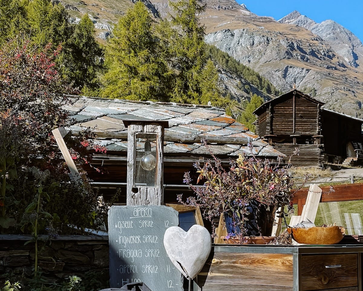 Chalkboard menu outside with a list of flavoured aperos. 