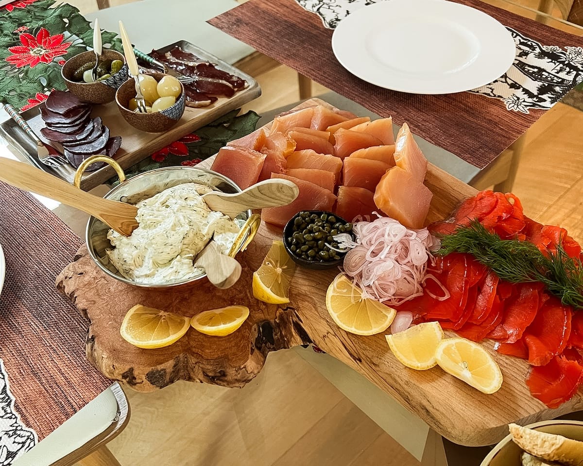 Smoked salmon, smoked tuna and accoutrements on a wooden board 